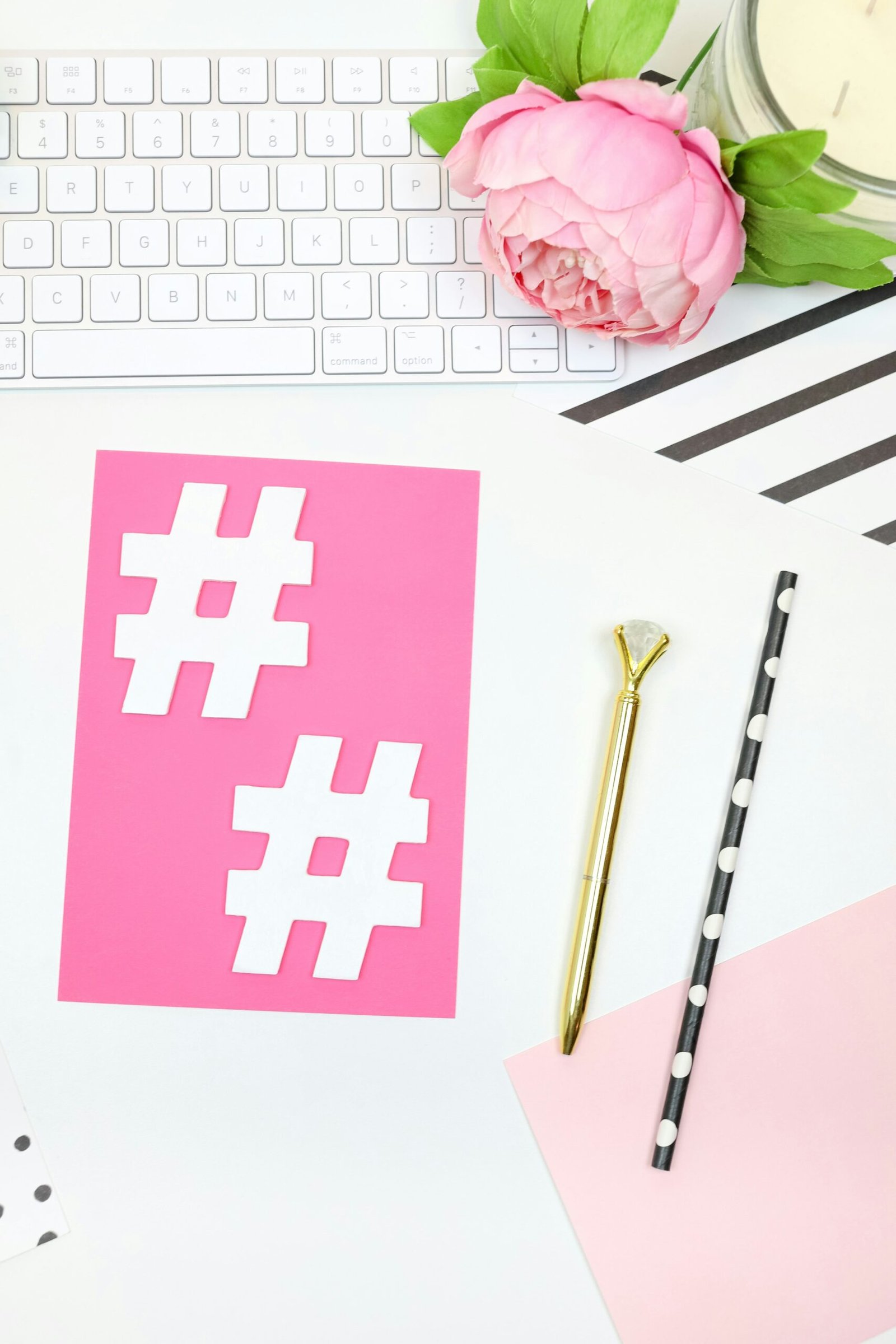 pink and white heart print card on white and gray computer keyboard